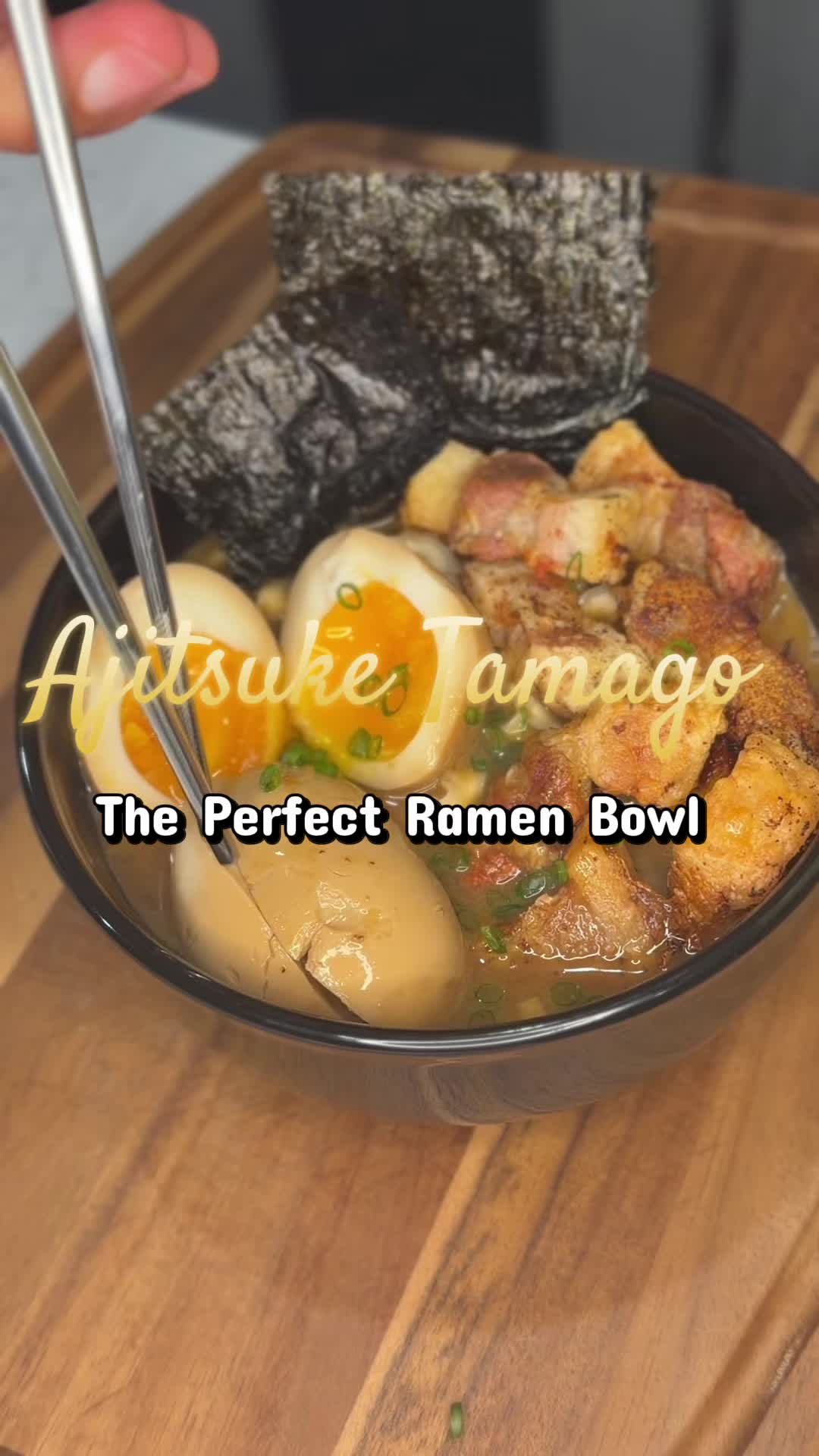 Homemade ramen bowl with soy eggs, crispy pork, fresh noodles, and scallions